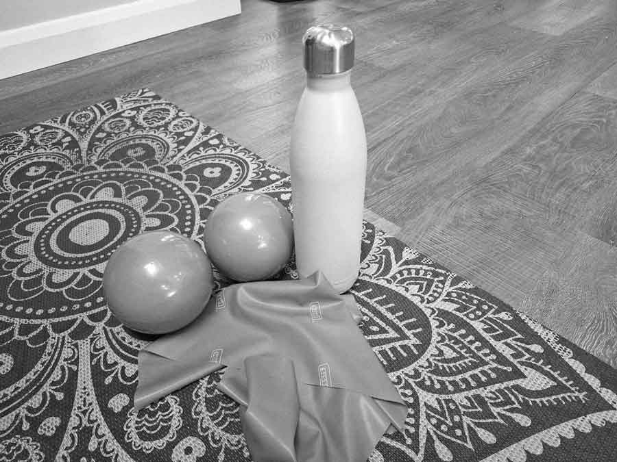 Weighted toning balls and a resistance band. Equipment which can be used in Pilates to add resistance, which helps build strength improving bone density and lowering the risk of osteoporosis. Strength classes available online from Fit and Alive.